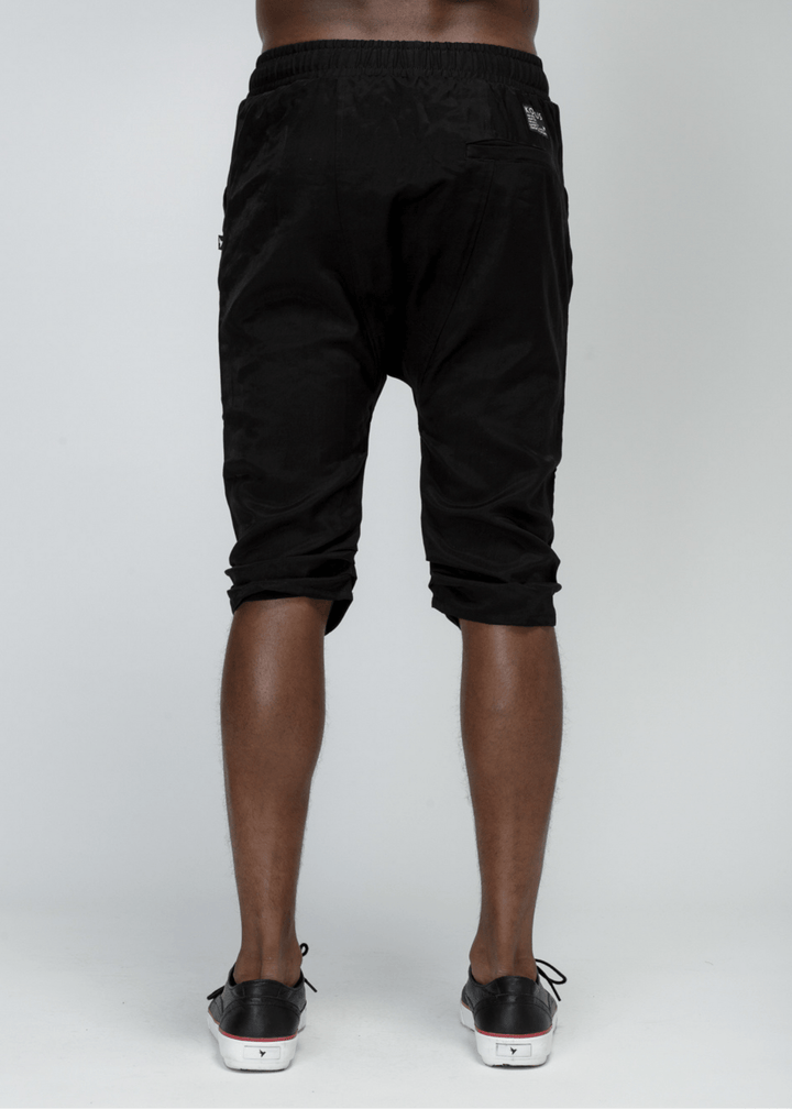 Konus Men's Drop Crotch Over Knee Shorts in Black by Shop at Konus